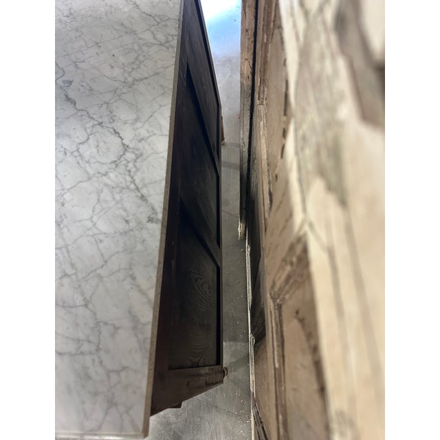 Louis xvi style mahogany and mahogany veneer commode, circa 1970. The front opens to reveal three rows of drawers with a...