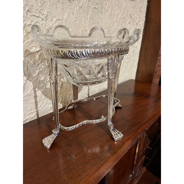 Heavy plated oval rack with ribbing supported by four legs ending in paw feet reinforced with serpentine stretchers. Heavy...