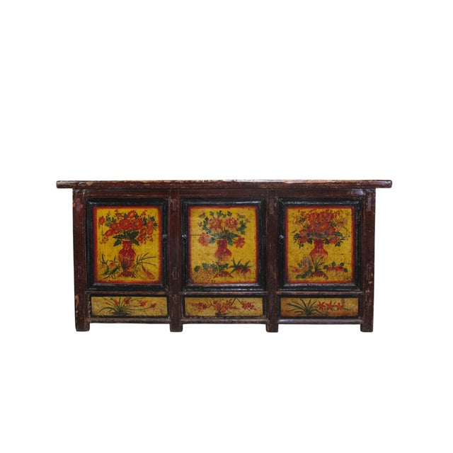 This late 19th century sideboard is handmade using sturdy pine and features vibrant, hand-painted floral panels on a warm...