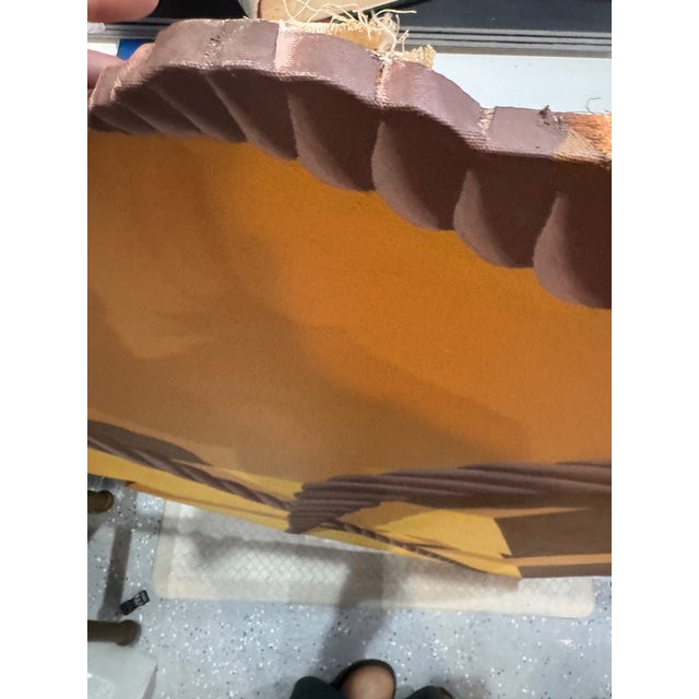 A striking and monumental trompe l'oeil shaped canvas painting depicting a geometric, angular package bound with heavy...