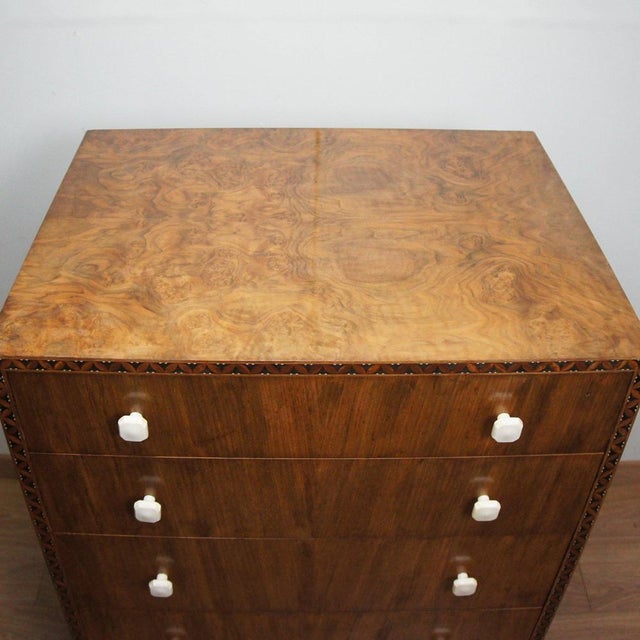 An Art Deco 'Lowboy' chest of drawers. Figured and burr walnut veneered with intricate satinwood and ebonised inlay and...