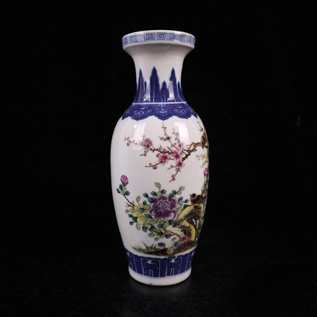 This elegant pair of Famille Rose porcelain vases showcases the exquisite craftsmanship of traditional Asian ceramics. The...