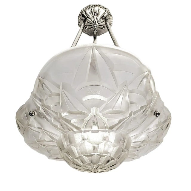 A French Art Deco pendant chandelier signed by the French artist “Degue“. Clear frosted molded glass shade with intricate...