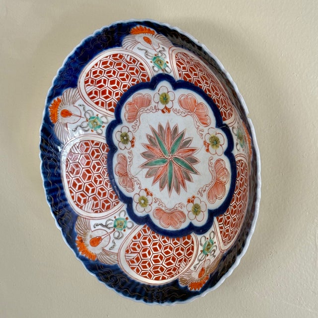 An antique Japanese Imari porcelain bowl in the classic palette of cobalt, iron red, and gilt. Richly hand-decorated and...