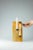 In Levature, the solidity of the stone is traversed by two precise incisions that accommodate burnished metal elements,...