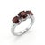 This striking ring features three round-cut garnet gemstones, each radiating a deep, rich red hue that embodies passion,...
