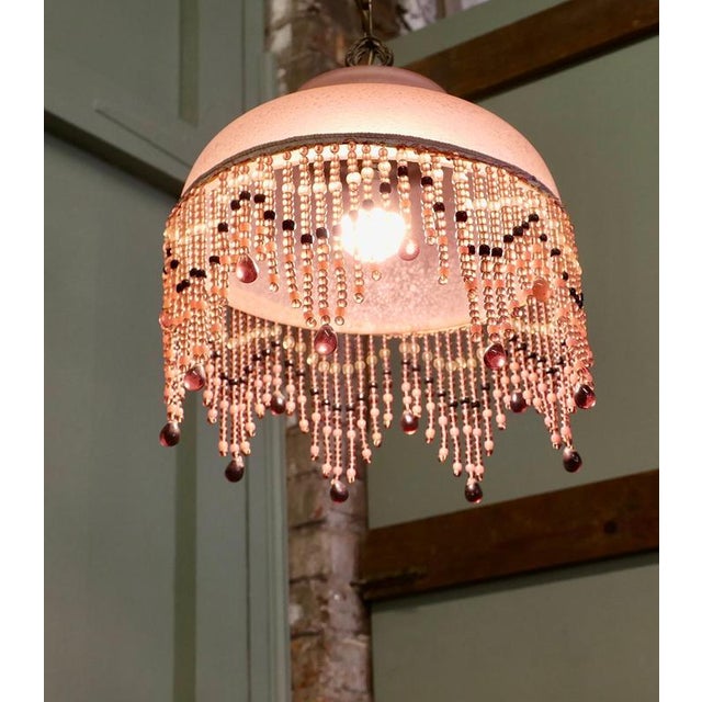 French Art Deco Glass Pendant Light with Beaded Shade A very pretty piece, this lovely lamp is made in brass with a beaded...
