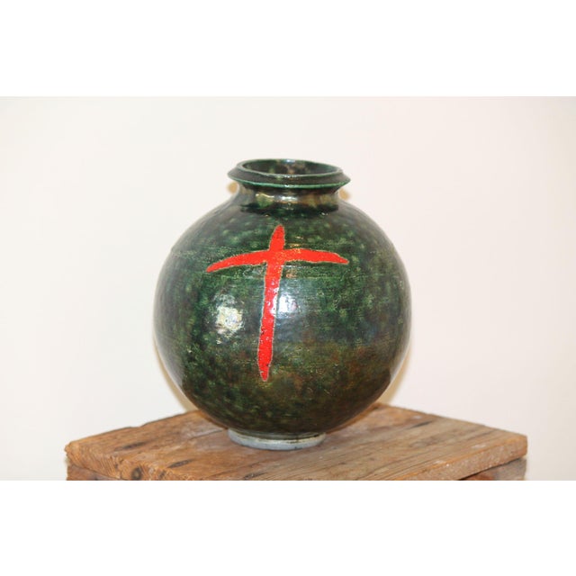 This is a beautiful Raku vase in a deep green color, decorated with a simple red cross, giving it a bit of a gothic feel....