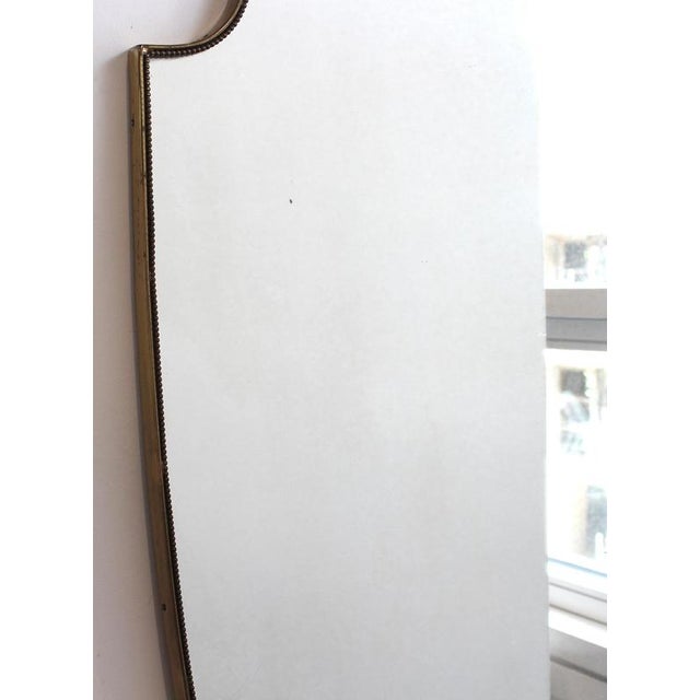 Mid-Century Italian wall mirror with brass frame and beading (circa 1960s). This mirror is simply elegant and characterful...