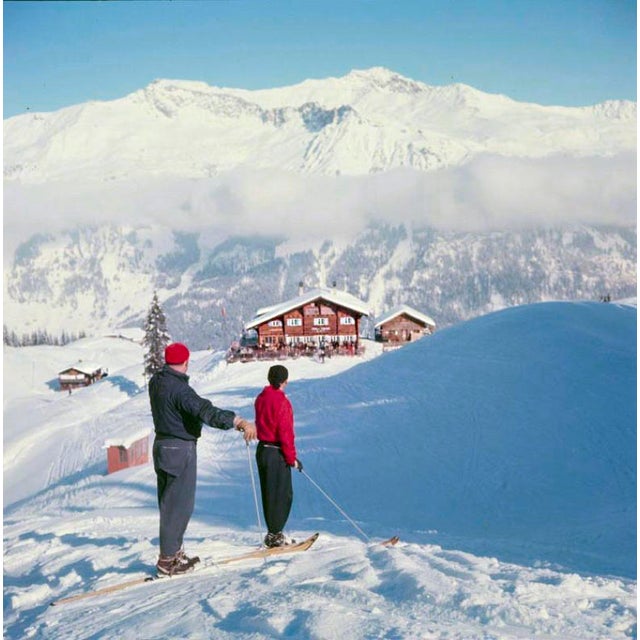 Skiers In The Alps by Toni Frissell Skiers stand and take in a classic alpine scene, Klosters, 1951. (Photo by Toni...