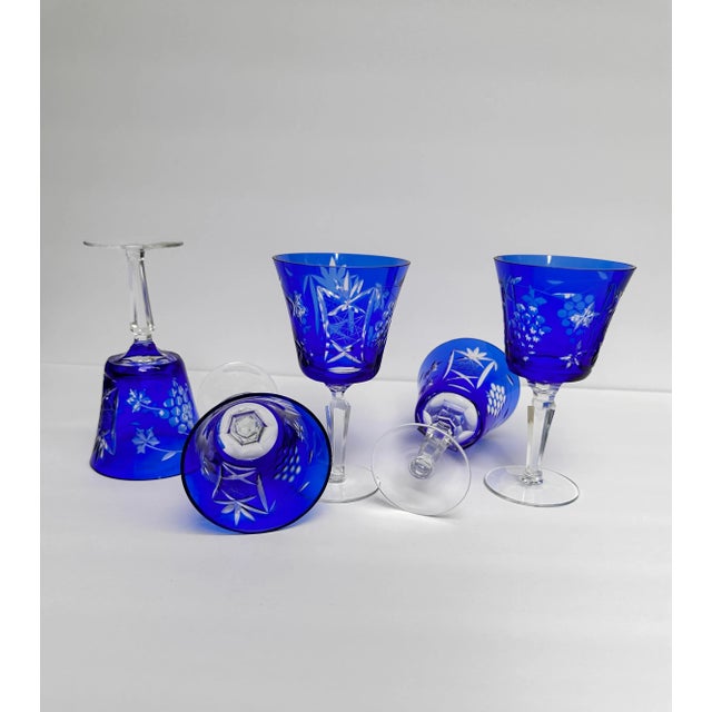 Set of 5 Cobalt blue stemmed cut to clear wine crystal. Grapes, stars, and fan cut motif. Excellent condition of 4 One has...