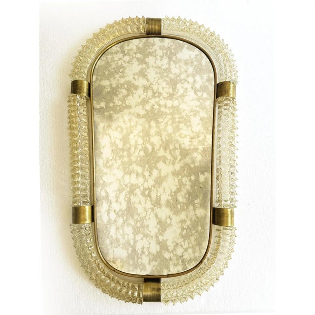 Luxury and scenographic "rostrato" gold murano glass wall mirror . impressive wall mirror in brass elements with...