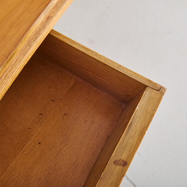 A 1950s Italian desk attributed to Gianfranco Frattini, crafted from warm-toned wood. The tabletop’s subtle curvature and...