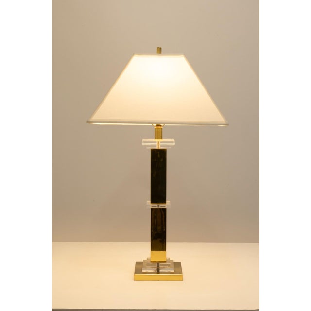 This 1950s table lamp by Frederick Cooper showcases a refined balance of modern materials and timeless design. The piece...