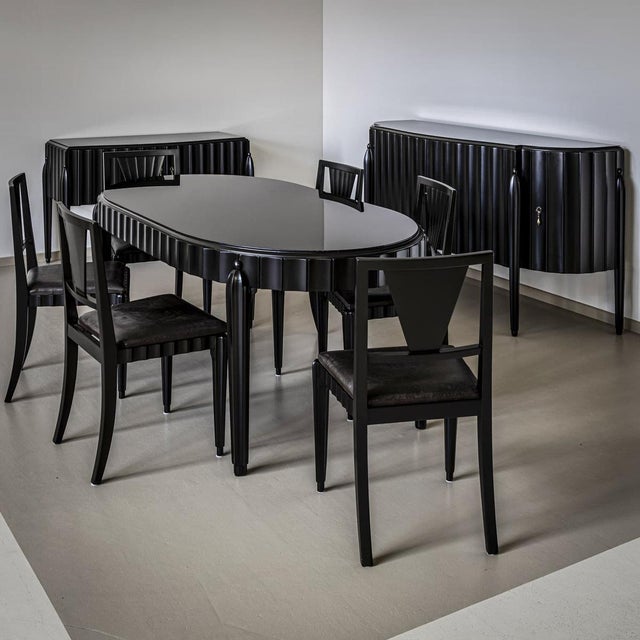 Art Deco dining room consisting of a sideboard, a dining table and six side chairs. The furniture is ebonized. Decorative...