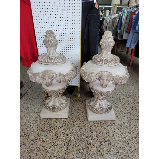 Vintage Concrete Urns With Rams Heads & Garlands sold as found in vintage condition previously owned and used.