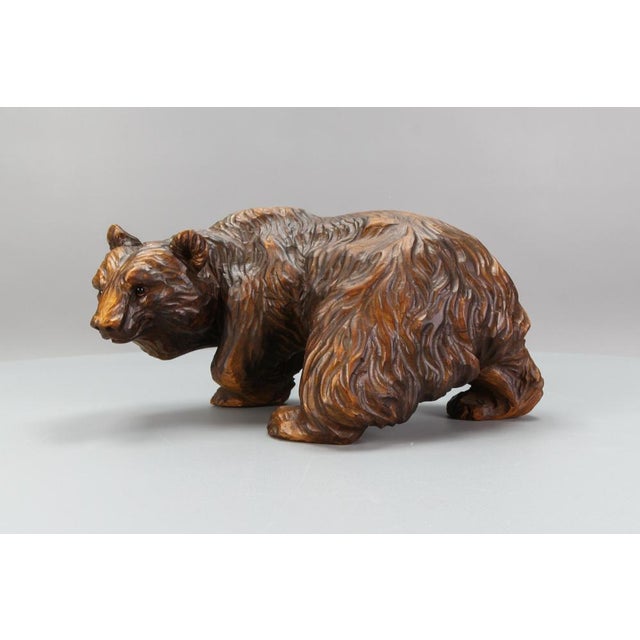 Hand-carved bear sculpture with glass eyes, Germany, circa the 1930s. A beautiful and masterfully hand-carved linden-wood...