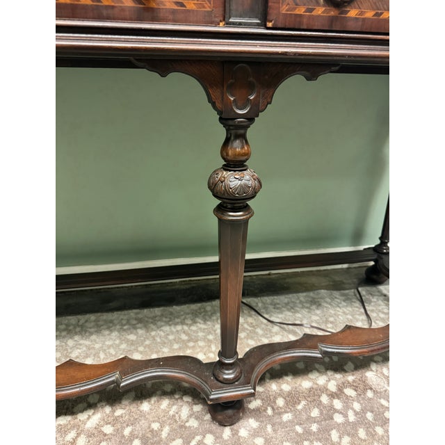 A beautiful English antique William and Mary style sideboard with ornate carved legs, bun feet and two drawers, one...
