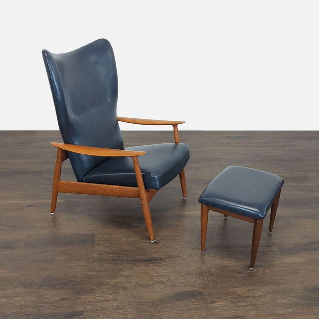 Relax in style with this John Boné lounge chair and ottoman set. Featuring a sturdy wooden frame and comfortable leather...