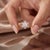 Exuding soft, romantic charm, this botanical ring showcases a blooming halo of delicate blush-pink gemstones surrounding a...