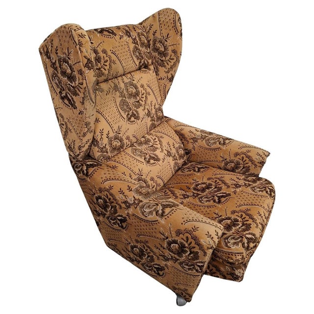 A mid-century upholstered wingback recliner chair produced in Czechoslovakia in the 1970s. Covered in its original woven...
