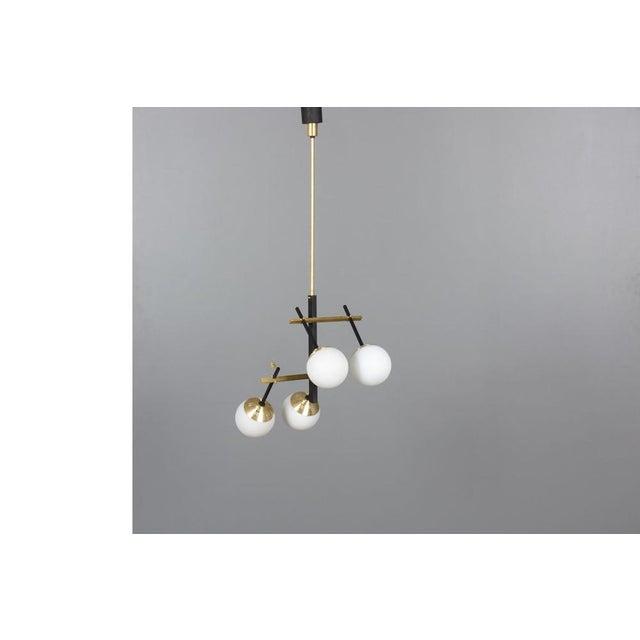 Pendant light from the fifties 3 principal materials: black metal, brass, opaline glass 4 light points Original design Up...