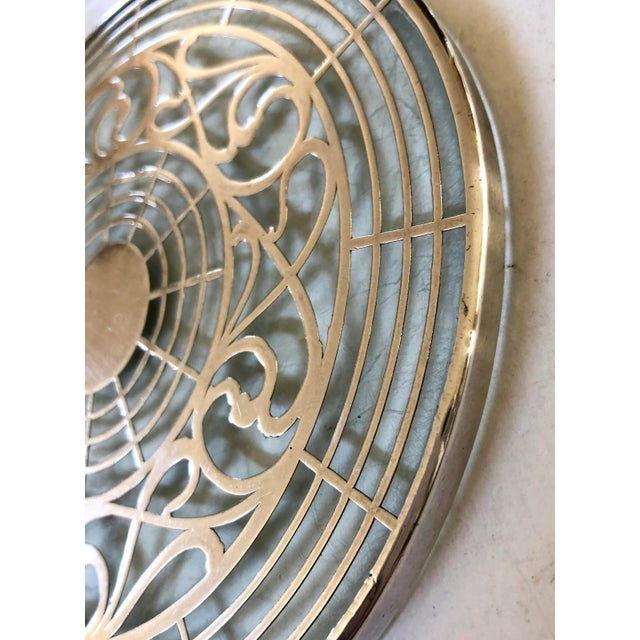 An elegant way to protect your table with this trivet that has a delicate Art Deco pattern of silver overlay on glass....