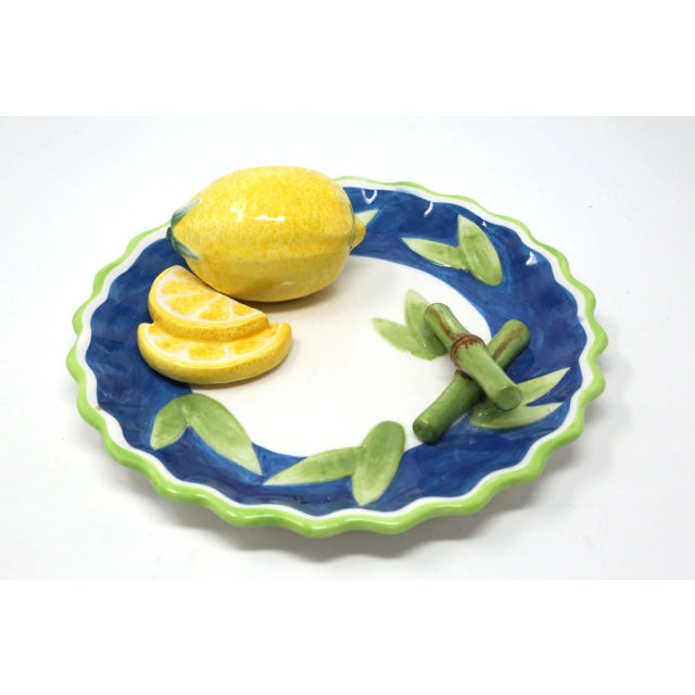 A 8-inch, hand-painted ceramic plate, with figurative lemon fruit and bamboo pieces. Good condition.