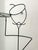 Whimsical standing, black metal, Memphis style sculptural wine rack in a French waiter design. Wire platter has glass...