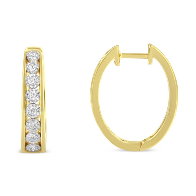 Brilliant diamonds set in 10 karat two-tone gold add sparkle to this pair of elegant hoop earrings. Each earring features...