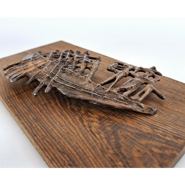 Striking mid-century wall relief in sculpted copper, depicting an abstracted boat with figures, signed by Swedish artist...