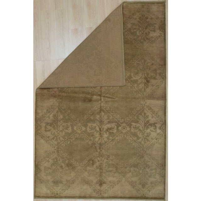 Trara Bespoke Beige Hand Knotted Wool Rug, Country of Origin: China. This exquisite piece represents the modern evolution...