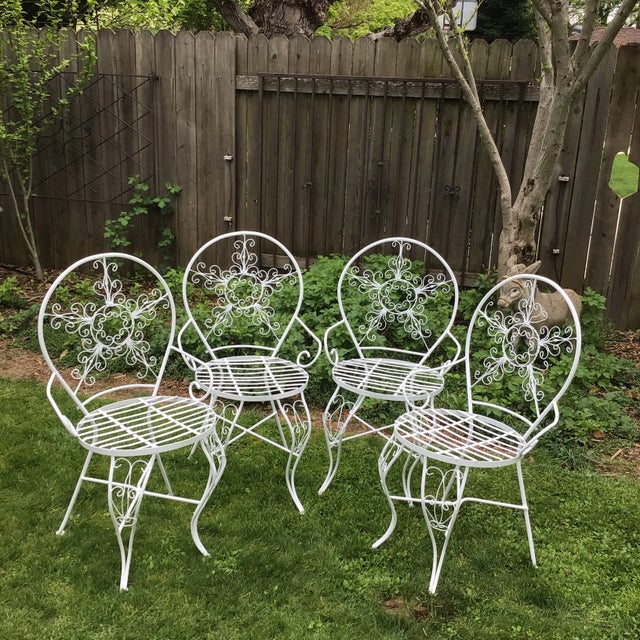 Beautiful ornate set of 4 chairs with arms. In very sturdy usable condition. They are metal with white paint. The seat...