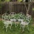 Beautiful ornate set of 4 chairs with arms. In very sturdy usable condition. They are metal with white paint. The seat...