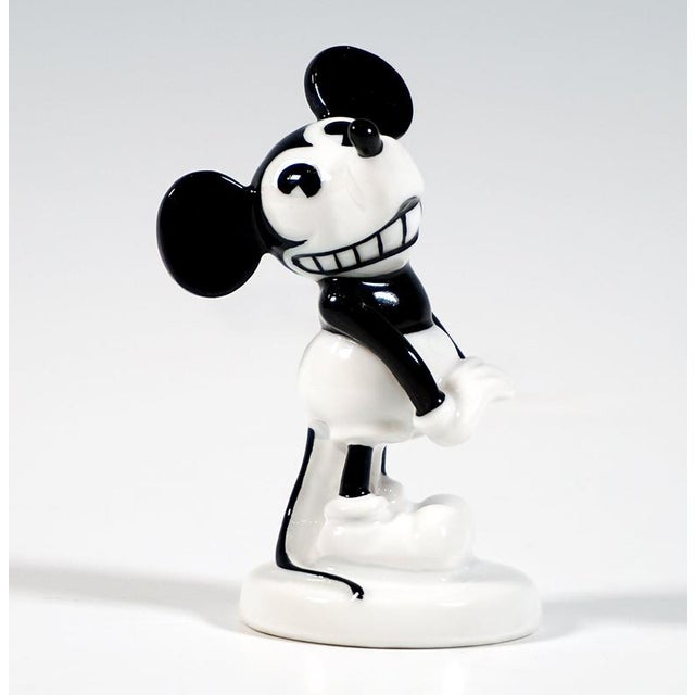 Admirable Rosenthal Figurine: A standing Mickey Mouse, with his palms pressed together at the front and pointing...