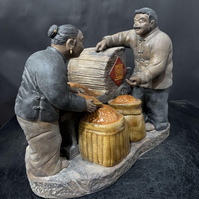 This expressive handcrafted Shiwan pottery sculpture depicts an elderly farmer couple celebrating a bumper grain harvest....