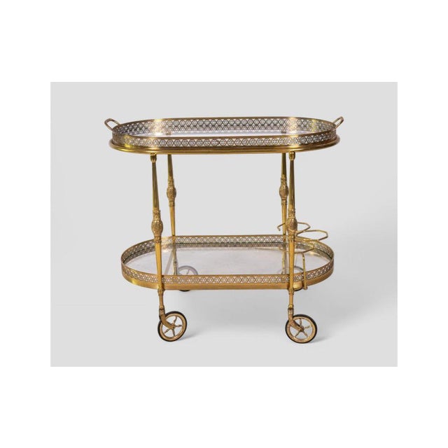 Elegant and eye-catching, this refined 1950s vintage bar cart is a fine example of Hollywood Regency design—perfect for...