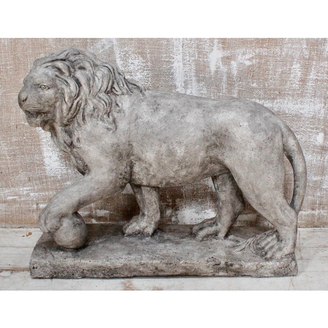 A lovely Medici Lion Garden Statue. This lion is majestically posed with a front foot resting on a ball and mounted on a...