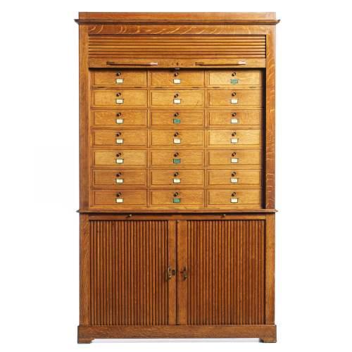 French, in oak wood, from the mid-20th century, upper part with a mat door with twenty-four small doors inside. Lower part...