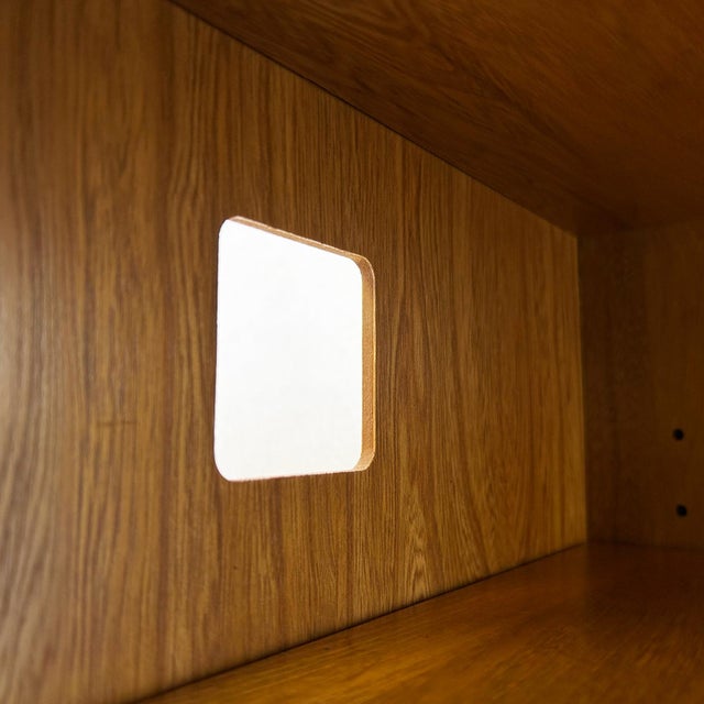 Solid elm construction on a plinth base with exposed finger-jointed corners. Upper section contains an adjustable shelf...