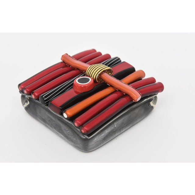 This fun glass abstract artisan paperweight is signed in cursive N Laso and from the 90's. The abstract designs on the top...