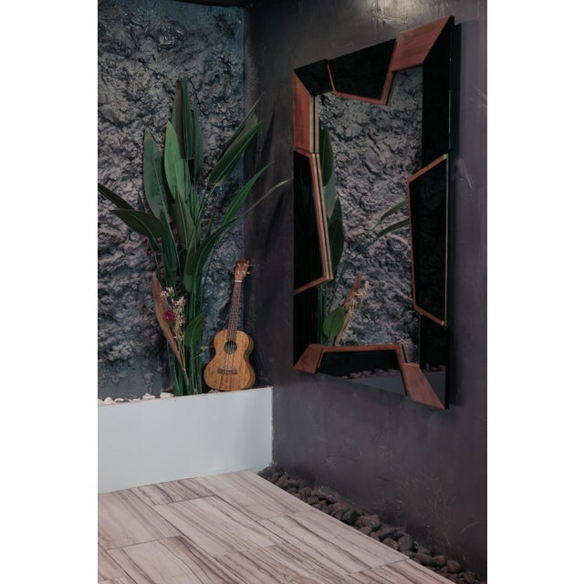 This mirror is a triumph of modern craftsmanship, beautifully framed in rich, natural walnut. The design features a...