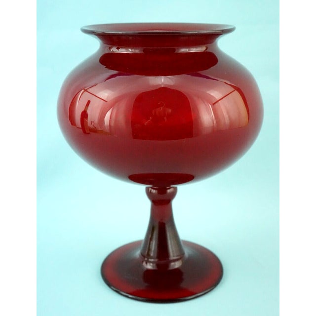 A fabulous scarlet red glass vase, crafted from the finest blown glass, with a voluminous belly culminating in an equally...