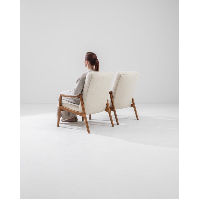 Immerse yourself in the timeless sophistication of a pair of 1960s Czechia Upholstered Chairs. Draped in pristine white...