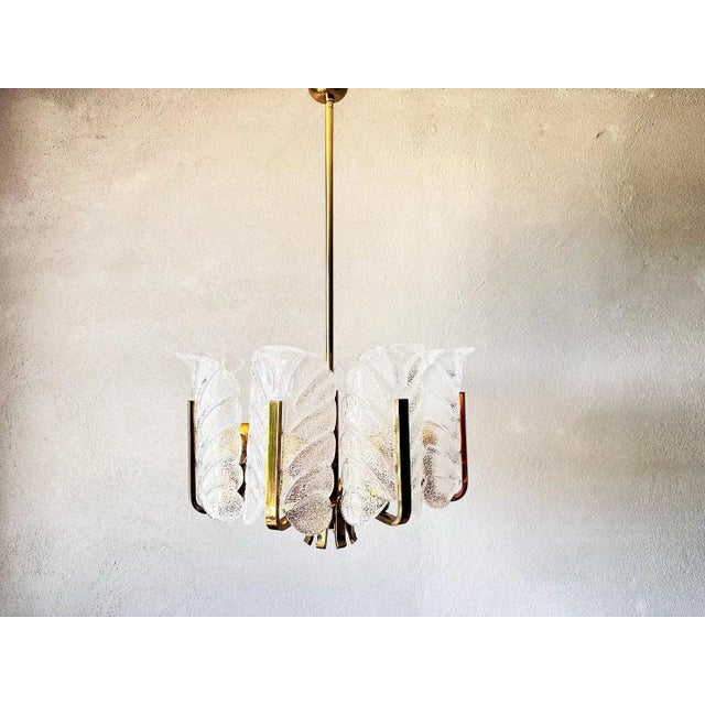 Beautiful 1960s Swedish design. Designed by Carl Fagerlund for Orrefors. Sleek brass frame with eight arms, from which...