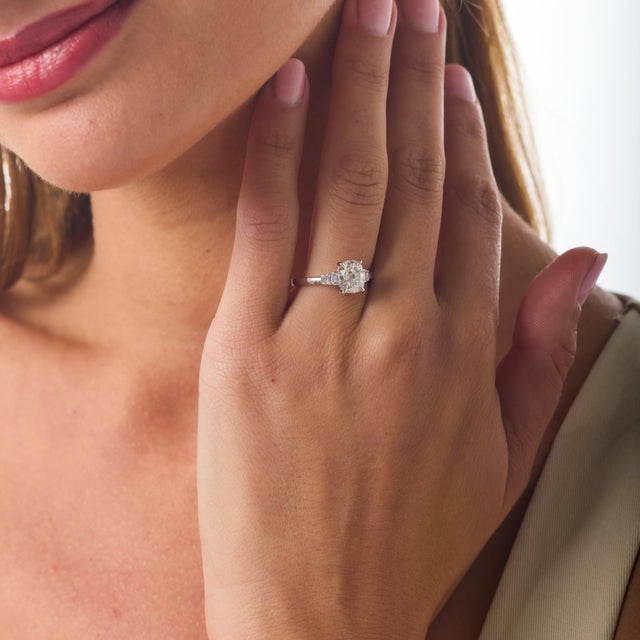 This modern engagement ring centers on a beautifully proportioned 1.51 carat GIA-certified cushion brilliant diamond whose...