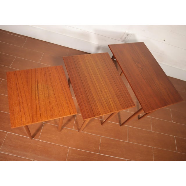 Beautiful vintage classic set of 3 teak nesting tables. Made In Denmark, manufacturer unknown. They are in good vintage...