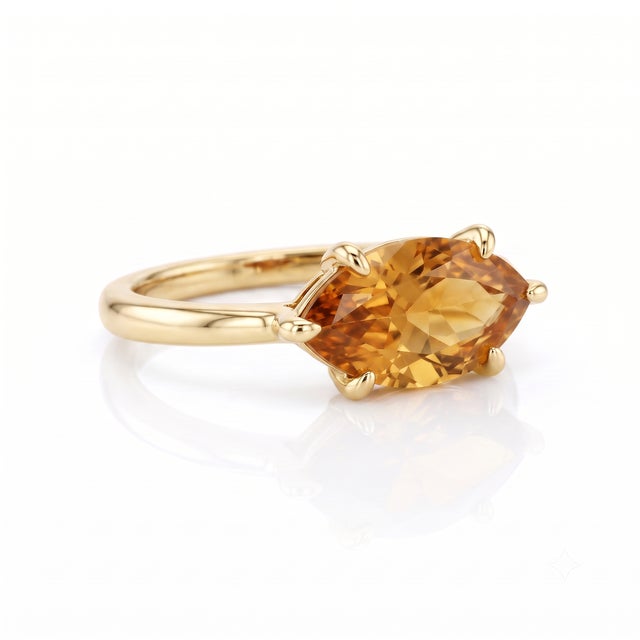 Capture the warmth of golden sunshine with this sparkling natural citrine solitaire ring. Set in a sleek horizontal...