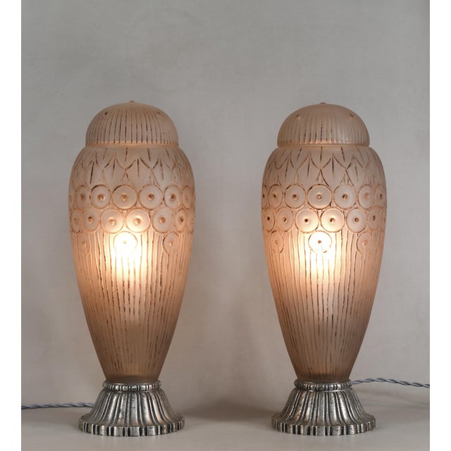 Genet et Michon A very rare pair of large French art deco lamps in patinated clear frosted molded-pressed glass. Made...