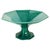 An elegant ceramic fruit bowl resting on a faceted pedestal base, inspired by Art Deco geometric lines. Its octagonal...